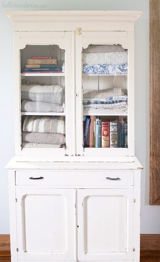 Use a charming old cabinet as a farmhouse linen cabinet